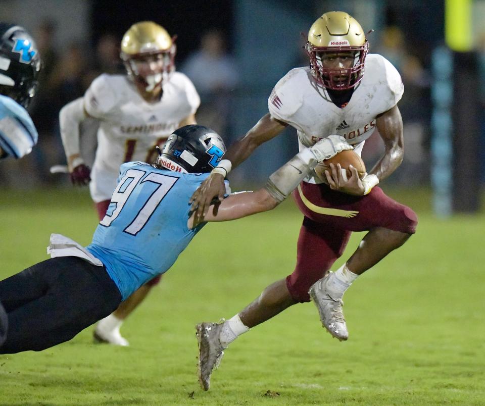 Florida State's Donovan Barnes eludes the tackle attempt by Ponte Vedra's DE Spencer Pearson (97) during late second quarter action. The Ponte Vedra High School Sharks hosted Florida State University High School Friday, September 2, 2022.