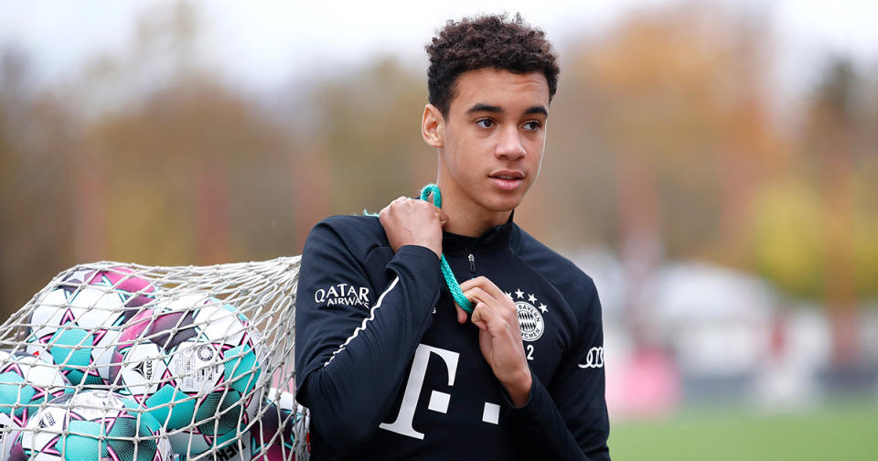   Jamal Musiala of FC Bayern Munich carries a net with balls during a training session at Saebener Strasse training ground on October 30, 2020 in Munich, Germany. 