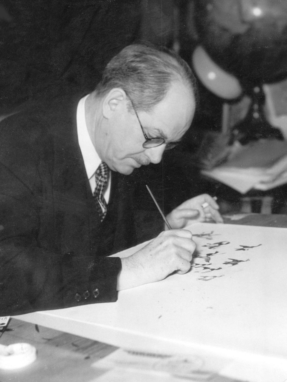 J.N. "Ding" Darling, editorial cartoonist for the Des Moines Register from 1906 to 1949 and winner of two Pulitzer Prizes, works on an editorial cartoon.