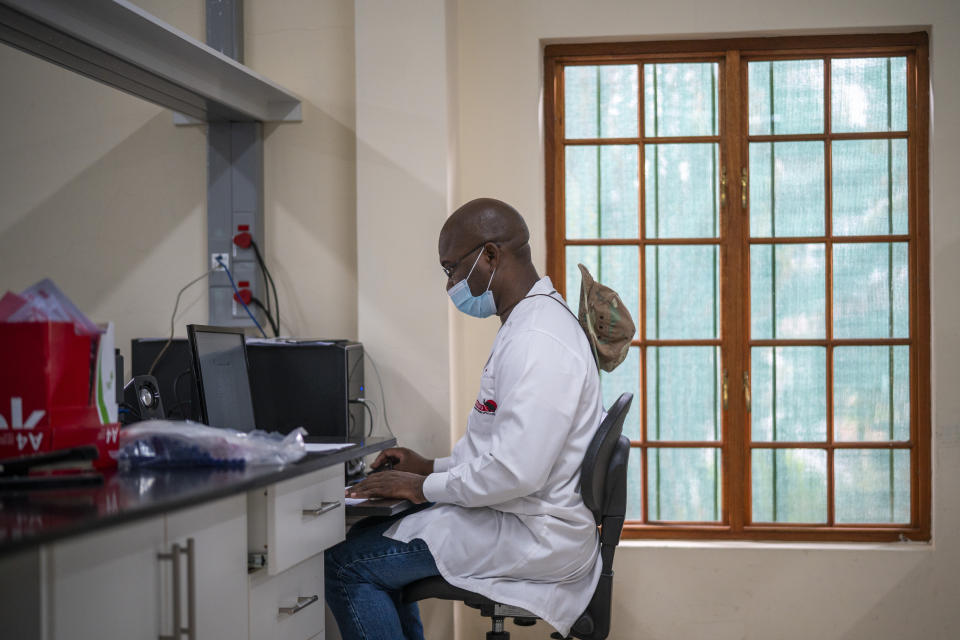 Richman Mkhomole captures data at the Ndlovu Research Center in Elandsdoorn, South Africa Wednesday Dec. 8, 2021. The centre ls part of the Network for Genomic Surveillance in South Africa, which discovered the omicron variant. (AP Photo/Jerome Delay)