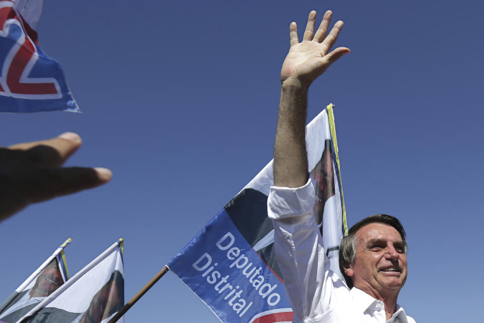 FILE - In this Sept. 5, 2018 file photo, Jair Bolsonaro, National Social Liberal Party presidential candidate, greets supporters during a campaign rally in Brasilia, Brazil. Now that former President Luis Inacio Lula da Silva has been bumped off the ballot for a corruption conviction, Bolsonaro is leading in the polls, apparently with the aid of evangelical backers. (AP Photo/Eraldo Peres, File)