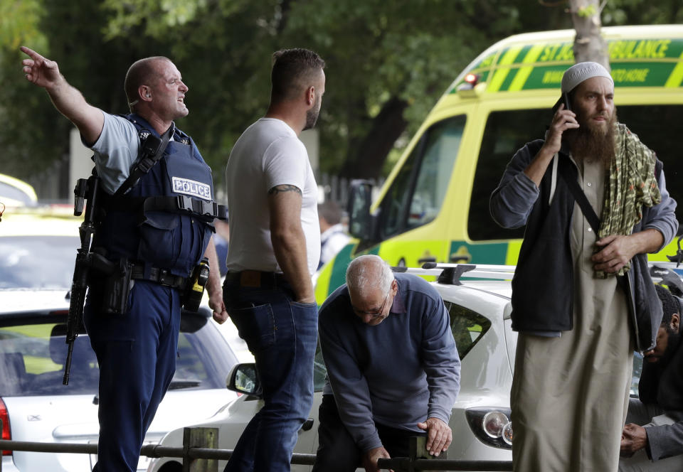 FILE - In this March 15, 2019, file photo, police attempt to clear people from outside a mosque in central Christchurch, New Zealand. New Zealand police on Wednesday, April 17, 2019 released a detailed timeline of their response to the March 15 shootings that left 50 dead at two Christchurch mosques, confirming they arrested the suspected shooter 18 minutes after receiving the first emergency call. (AP Photo/Mark Baker, File)