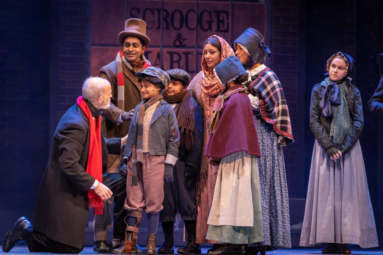 Scrooge meets Tiny Tim in the 2021 production of "A Christmas Carol" at the Hanover Theatre for the Performing Arts.
