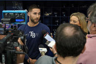 Tampa Bay Rays' Kevin Kiermaier, left, talks to reporters before a baseball game against the Toronto Blue Jays Wednesday, Sept. 22, 2021, in St. Petersburg, Fla. Kiermaier was answering questions about him picking up the Blue Jays pitch data card after being tagged out at home plate by catcher Alejandro Kirk during Monday's game. (AP Photo/Chris O'Meara)