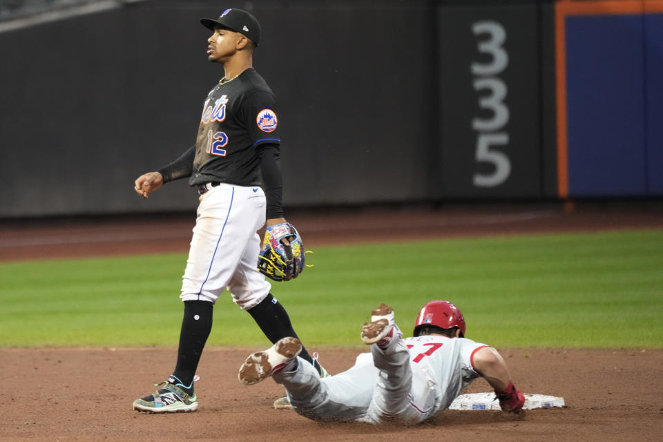 Philadelphia Phillies' Weston Wilson steals second base past New York Mets shortstop Francisco Lindor (12) during the ninth inning of the first game of a baseball doubleheader Saturday, Sept. 30, 2023, in New York. The Mets won 4-3. (AP Photo/Mary Altaffer)