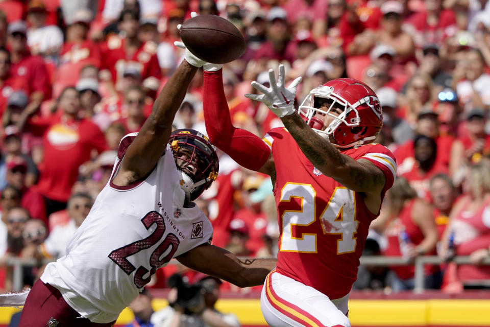 Washington Commanders cornerback Kendall Fuller (29) breaks up a pass intended for Kansas City Chiefs wide receiver Skyy Moore (24) during the first half of an NFL preseason football game Saturday, Aug. 20, 2022, in Kansas City, Mo. (AP Photo/Ed Zurga)