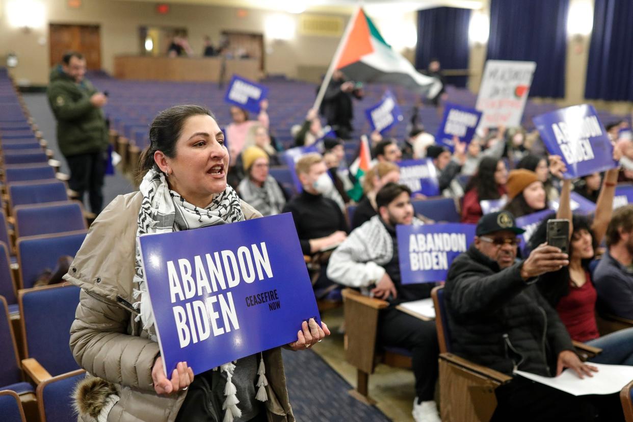 Farah Khan, of Northville, leads a chant "Ceasefire Now" during a community rally to boycott President Biden's visit at Fordson High School in Dearborn on Jan. 31, 2024.