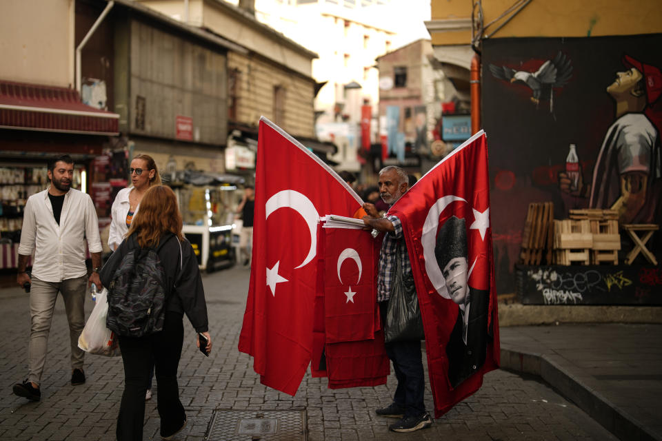 A street vendor sells Turkish flags, some with an image of Mustafa Kemal Ataturk, in Istanbul, Turkey, Wednesday, Oct. 25, 2023. The Turkish Republic, founded from the ruins of the Ottoman Empire by the national independence hero Mustafa Kemal Ataturk, turns 100 on Oct. 29. Ataturk established a Western-facing secular republic modeled on the great powers of the time, ushering in radical reforms that abolished the caliphate, replaced the Arabic script with the Roman alphabet, gave women the vote and adopted European laws and codes. (AP Photo/Emrah Gurel)