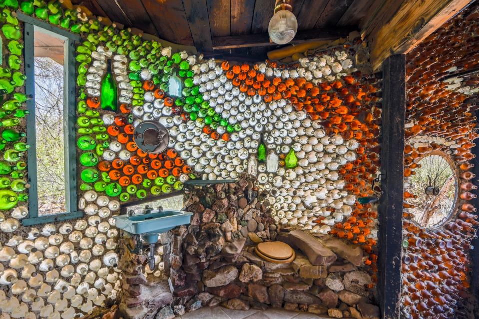 Bathroom in a unique home made out of recycled bottles and rocks at 1800 N Camino Altar, Tucson, Arizona, is for sale. It is listed by Holly Greenhalgh of Coldwell Banker Realty for $432,500, and was recently featured on Zillow Gone Wild.