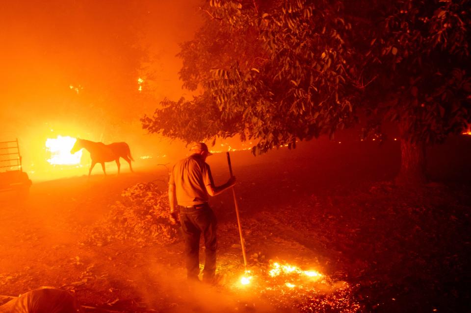 Bill Nichols, 84, works to save his home as the LNU Lightning Complex Fire tears through Vacaville, Calif., on Aug. 19. Nichols has lived in the home for 77 years.