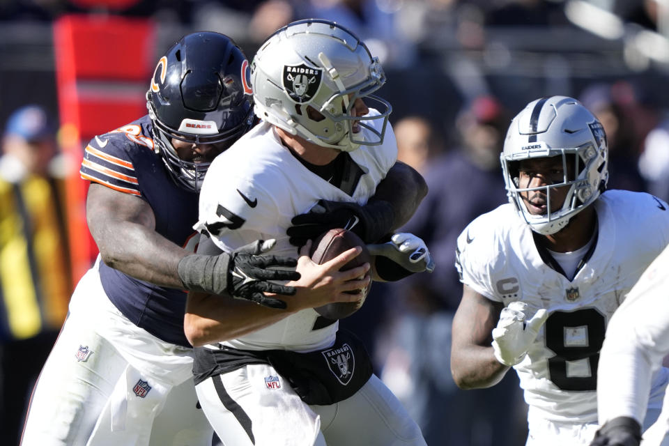 Chicago Bears defensive tackle Justin Jones (93) sacks Las Vegas Raiders quarterback Brian Hoyer (7) for an 8-yard loss in the second half of an NFL football game Sunday, Oct. 22, 2023, in Chicago. (AP Photo/Charles Rex Arbogast)