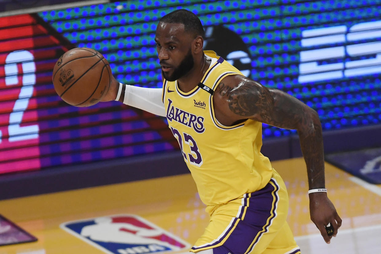 LOS ANGELES, CALIFORNIA - MAY 19: LeBron James #23 of the Los Angeles Lakers dribbles during the first half of an NBA Tournament Play-In game against the Golden State Warriors at Staples Center on May 19, 2021 in Los Angeles, California. NOTE TO USER: User expressly acknowledges and agrees that, by downloading and or using this photograph, User is consenting to the terms and conditions of the Getty Images License Agreement. (Photo by Kevork Djansezian/Getty Images)