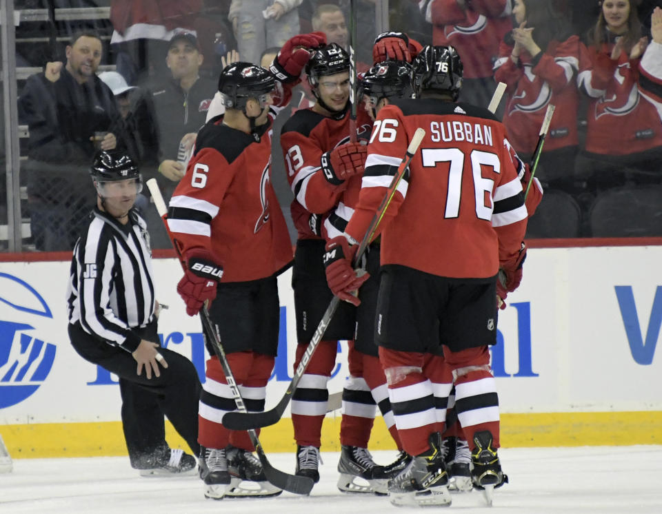 New Jersey Devils center Nico Hischier (13) celebrates his goal with teammates during the first period of an NHL hockey game against the Toronto Maple Leafs, Friday, Dec. 27, 2019, in Newark, N.J. (AP Photo/Bill Kostroun)