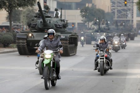 A group of policemen of motorcycles passes a convoy of tanks during the rehearsal parade for the Independence Day which will be held next Wednesday on November 22, in Beirut, Lebanon, November 18, 2017. REUTERS/Jamal Saidi