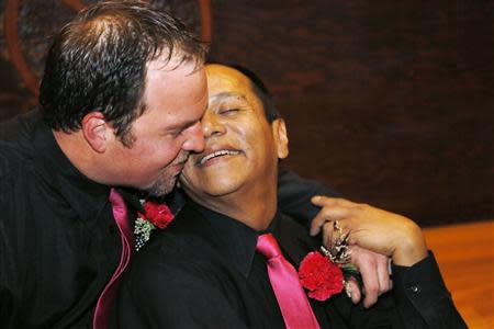 Darren Black Bear (R) and Jason Pickel wait for their wedding photographer after they were married by Darren's father Rev. Floyd Black Bear in El Reno, Oklahoma October 31, 2013. REUTERS/Rick Wilking