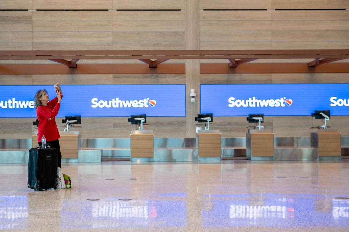 Jan Scaletta, a United test passenger, takes a photo during a simulation tour at the new single terminal at Kansas City International Airport on Tuesday, Feb. 14, 2023.