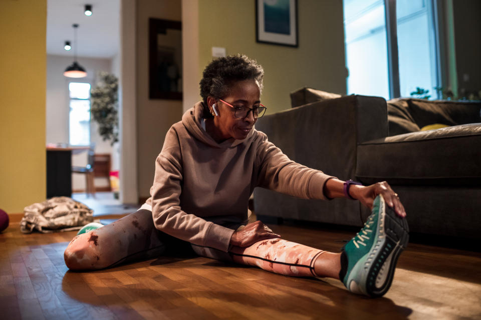 Woman exercising at home. (Getty Images)