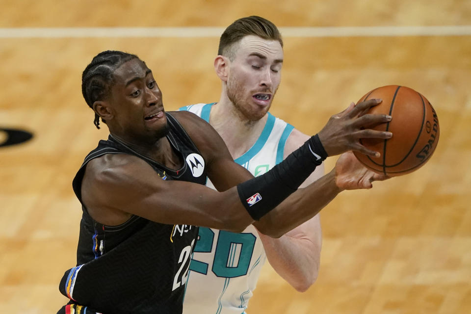 Brooklyn Nets guard Caris LeVert, left, drives around Charlotte Hornets forward Gordon Hayward during the first half of an NBA basketball game in Charlotte, N.C., Sunday, Dec. 27, 2020. (AP Photo/Chris Carlson)