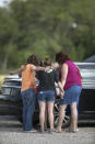 <p>Parents of Santa Fe High School students join in prayer at the parking lot of the Arcadia First Baptist Christian School accompanied by residents after a shooter open fired at the high school, Friday, May 18, 2018, in Santa Fe, Texas. (Photo: Marie D. De Jesus/Houston Chronicle via AP) </p>