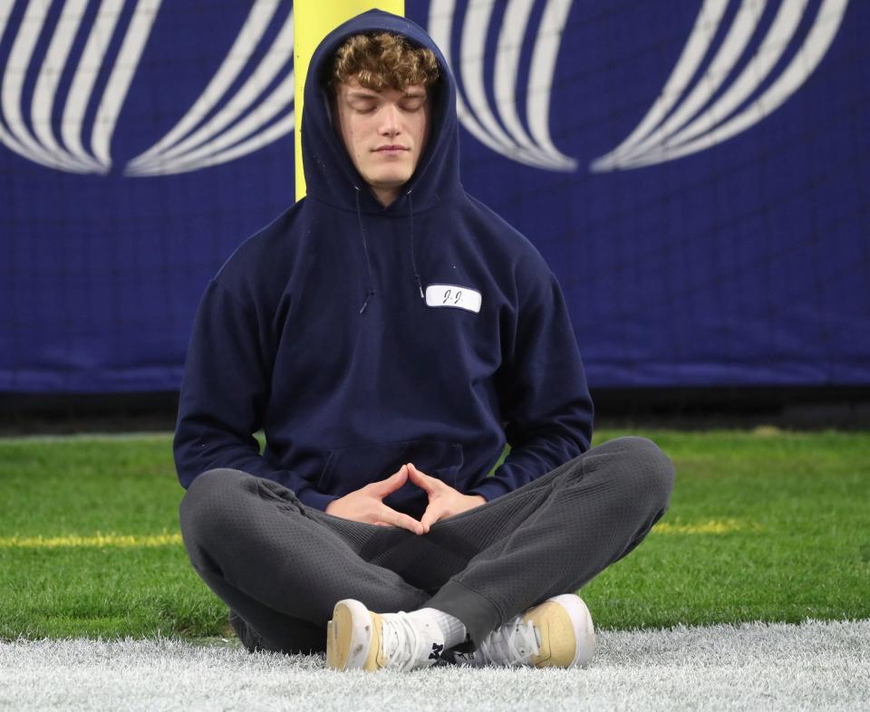 Michigan Wolverines quarterback J.J. McCarthy (9)  meditates before the Fiesta Bowl game against the TCU Horned Frogs on December 31, 2022.