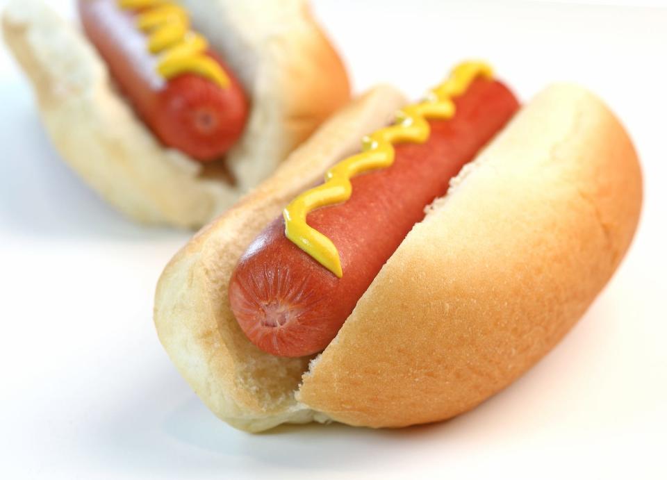 A hot dog with mustard.