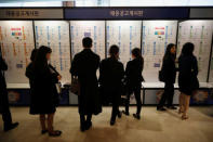 Jobseekers look at recruitment advertisements during the 2018 Japan Job Fair in Seoul, South Korea, November 7, 2018. Picture taken on November 7, 2018. REUTERS/Kim Hong-Ji