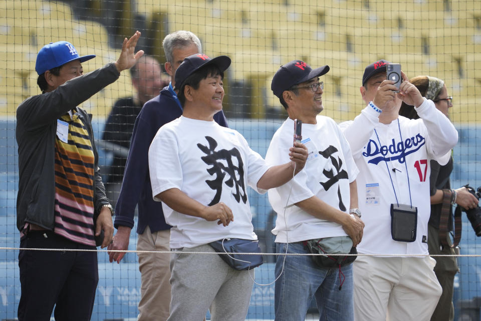 Los Angeles Dodgers fans wear Shohei Ohtani shirts as players workout before a baseball game against the Cincinnati Reds in Los Angeles, Thursday, May 16, 2024. (AP Photo/Ashley Landis)