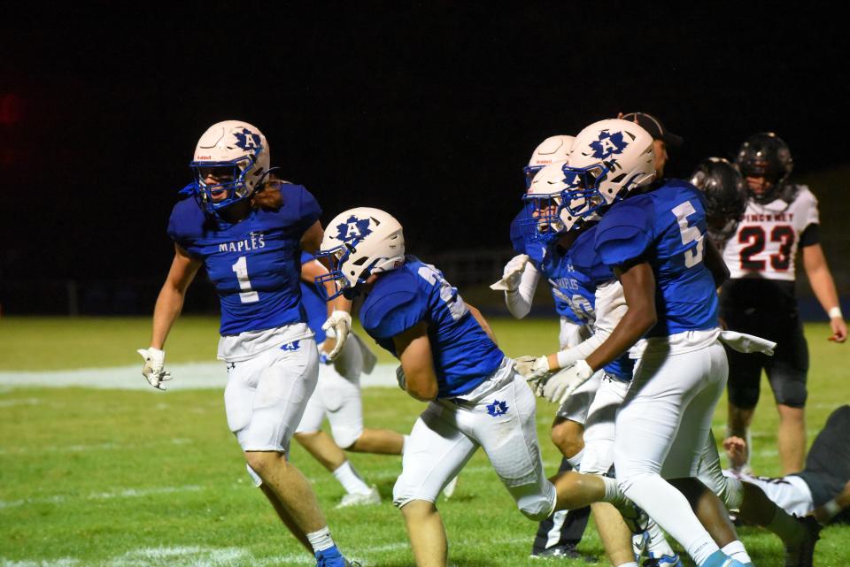 Adrian's kickoff team celebrates recovering a fumble during Friday's game against Pinckney.