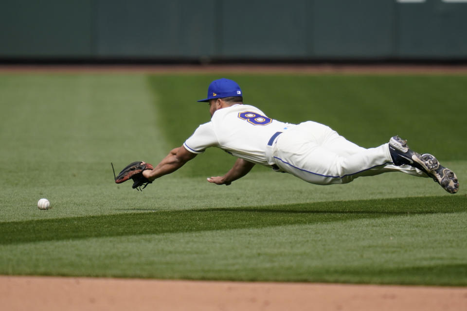Seattle Mariners second baseman Jack Mayfield dives for but can't get to a grounder for a single by Texas Rangers' Willie Calhoun in the sixth inning of a baseball game Sunday, May 30, 2021, in Seattle. (AP Photo/Elaine Thompson)