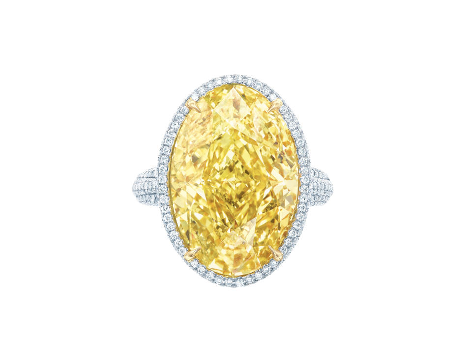 This image released by Tiffany's shows a 15.04ct Oval Fancy Vivid Yellow Diamond Ring with white diamonds and set in platinum and 18k yellow gold. (AP Photo/Tiffany's)