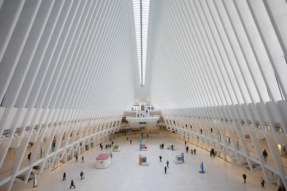 The Oculus at the World Trade Center's transportation hub is sparsely occupied, Monday, March 16, 2020 in New York. Millions of Americans have begun their work weeks holed up at home, as the coronavirus pandemic means the entire nation's daily routine has shifted in ways never before seen in U.S. history. (AP Photo/Mark Lennihan)