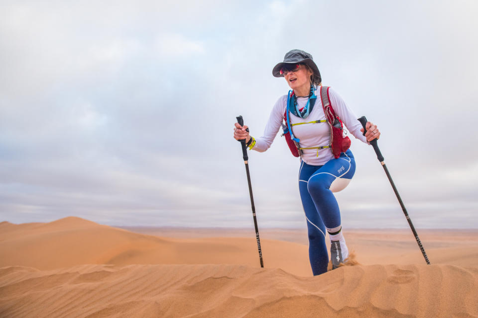 NAMIB DESERT, NAMIBIA - FEBRUARY 26:  Louise Minchin walks across the sand on Day 3 of the Sport Relief challenge: The Heat is On, as the team sets off on February 26, 2020 in the Namib Desert, Namibia. They are teaming up for Sport Relief to take on a 100-mile desert expedition over four days in which they will attempt to traverse the Namib desert in Namibia, Africa by foot, bike and ski (on sand) to reach a shipwreck on the notorious skeleton Coast. (Photo by Leo Francis/Comic Relief via Getty Images)