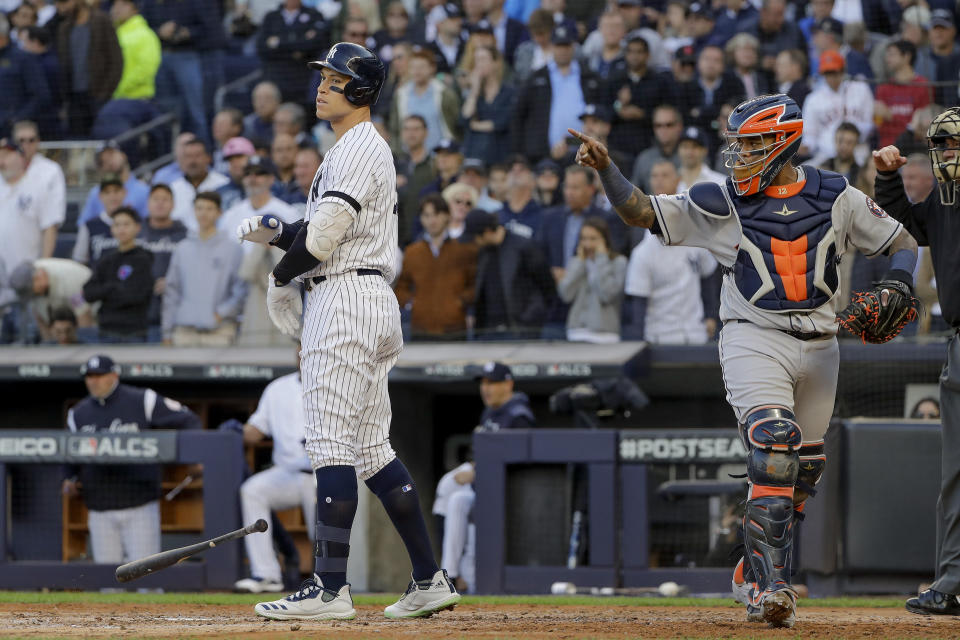 New York Yankees' Aaron Judge, left, reacts after striking out with two men on base to end the second inning against the Houston Astros during Game 3 of baseball's American League Championship Series, Tuesday, Oct. 15, 2019, in New York. (AP Photo/Frank Franklin II)