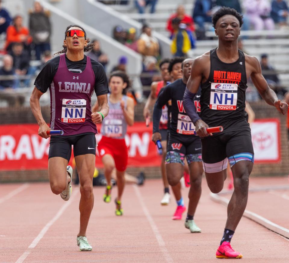 Leonia's Jaden Marchan finishes just behind Mott Haven's Marvin Merkland as Leonia takes second in their High School Boys 4X400 relay effort.