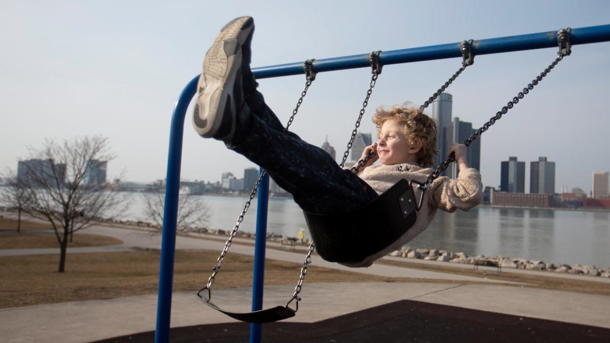 Theo Crantz, 6, enjoys the swing at Almer Riverfront Park on an unseasonably warm February afternoon, Monday, Feb. 26, 2024. (Dax Melmer/CBC - image credit)
