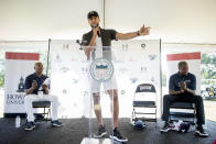 Golden State Warriors guard Stephen Curry speaks as Howard University Athletic Director Kery Davis, left, and Howard University interim president Wayne Frederick look on during a news conference at Langston Golf Course in Washington, Monday, Aug. 19, 2019, where Curry announced that he would be sponsoring men's and women's golf teams at Howard University. (AP Photo/Andrew Harnik)