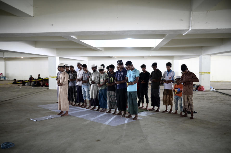 Rohingya men perform a noon prayer as they take shelter in the basement of a building in Banda Aceh, Aceh province, Indonesia, Tuesday, Dec. 12, 2023. Hundreds of Rohingya Muslims from two groups carried out by two boats arrived on beaches in Indonesia's Aceh province on Sunday. These groups have been denied to the Aceh residents who are hesitant to let them sheltered around their houses. (AP Photo/Reza Saifullah)