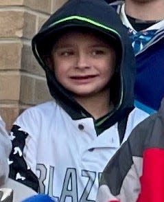 Jackson Sparks, 8, smiles for a photo with the Waukesha Blazers Baseball/Fastpitch Softball Club shortly before the Waukesha Christmas Parade began Sunday. Sparks was struck by the driver that plowed through the parade. He is the sixth person to die from his injuries in the parade, and the first child.