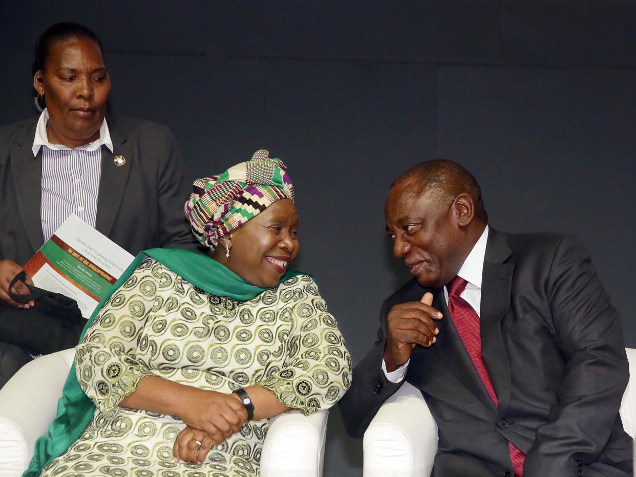 Nkosazana Dlamini-Zuma and Cyril Ramaphosa sharing a light moment at a conference in Durban, South Africa in 2015. If the rift between their two factions is not healed after the vote if could lead to a political crisis: Getty