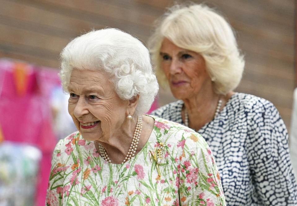 FILE - Britain's Queen Elizabeth II, foreground and Camilla, the Duchess of Cornwall attend an event in celebration of 'The Big Lunch 'initiative, during the G7 summit in Cornwall, England, Friday June 11, 2021. (Oli Scarff/Pool Photo via AP, File)