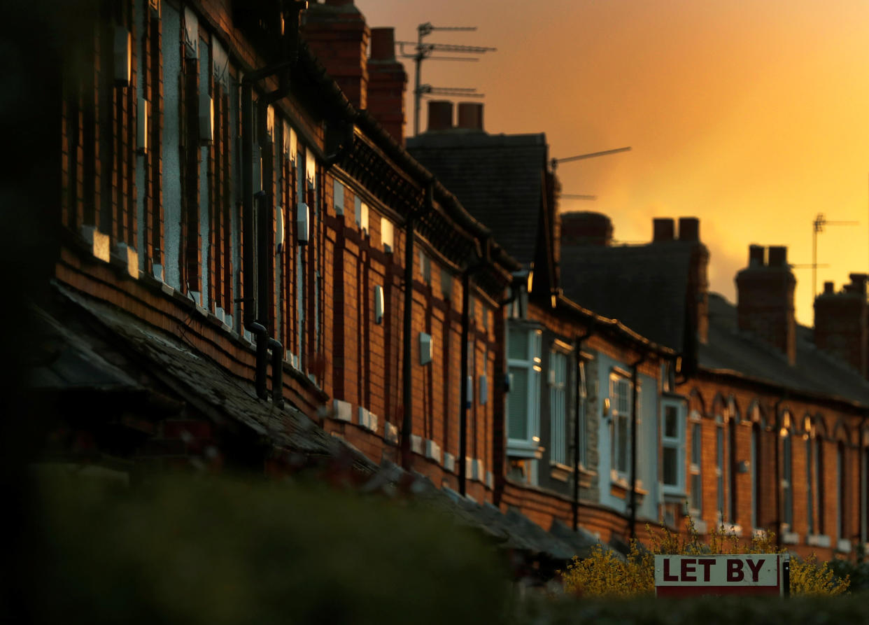 An estate agents sign for a house to rent is seen in front of a row of terraced houses in Altrincham northern England, April 16, 2016. REUTERS/Phil Noble