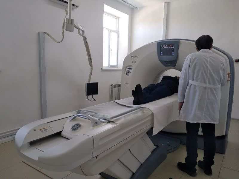 A medical worker carries out computed tomography scanning at a local hospital in Dagestan’s Gurbuki village