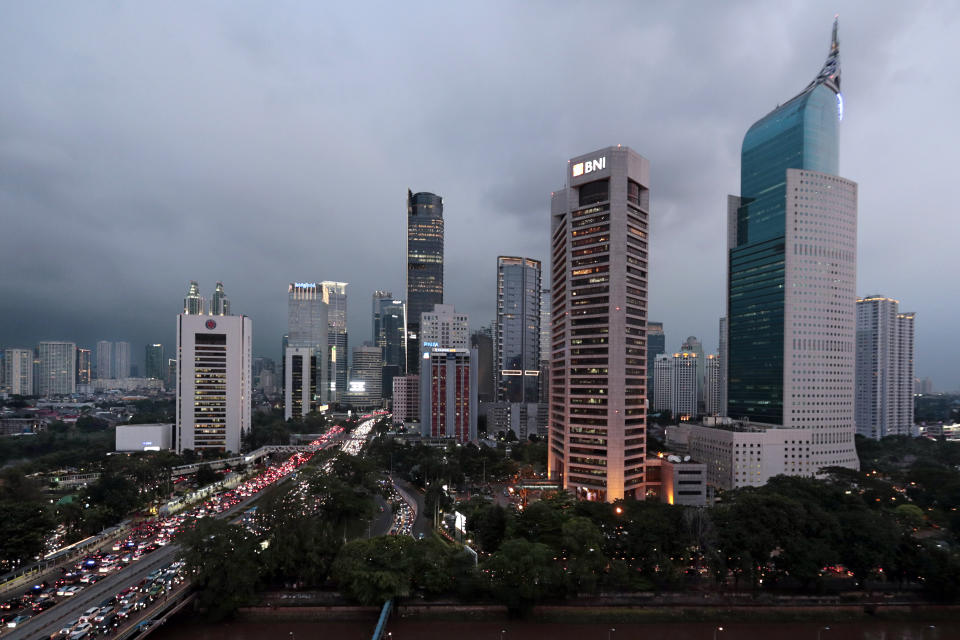 FILE — The central business district skyline is seen during the dusk in Jakarta, Indonesia, April 29, 2019. Indonesia's decades-long discussion about building a new capital has inched forward after President Joko Widodo approved a long-term plan for the government to abandon overcrowded, sinking and polluted Jakarta. (AP Photo/Dita Alangkara, File)