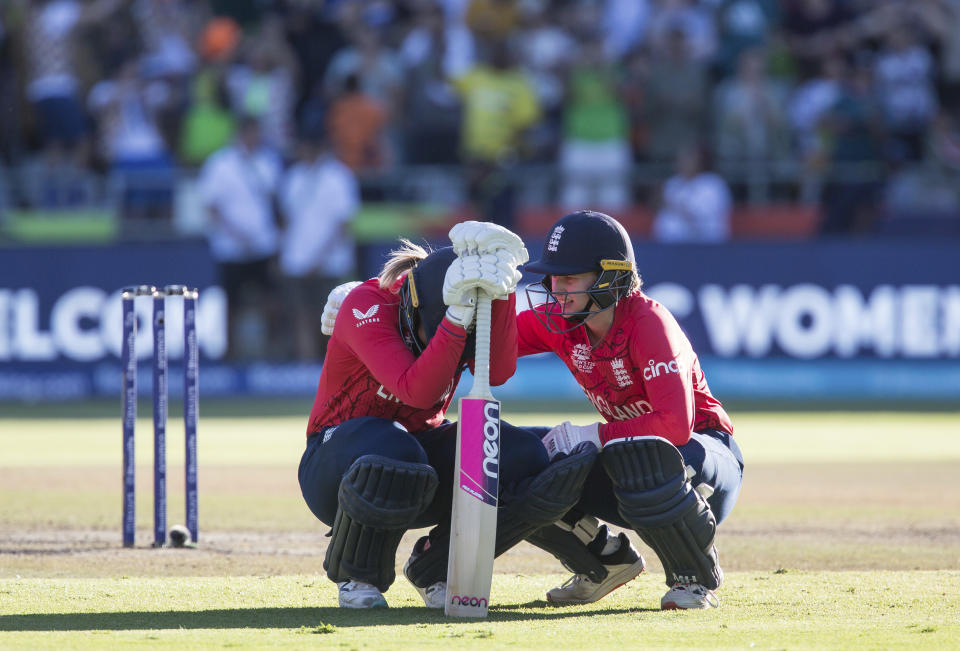 England's Amy Jones consoles England's Heather Knight after loosing to South Africa during the Women's T20 World Cup semi final cricket match in Cape Town, South Africa, Friday Feb. 24, 2023. (AP Photo/Halden Krog)