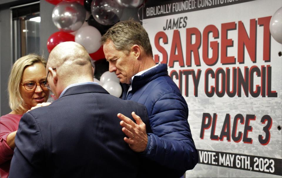 Norm Poorman, right, clasps Abilene City Council candidate James Sargent while Angel Poorman prays before Sargent spoke to supporters at his campaign announcement event at the First Baptist Church Family Life Center. Sargent is seeking Place 3 and faces two opponents. Jan 28 2023