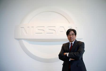 Nissan Executive Vice President Hideyuki Sakamoto poses with the carmaker's logo in the showroom at the carmaker's headquarters in Yokohama, Japan, January 13, 2017. Picture taken January 13, 2017. REUTERS/Toru Hanai