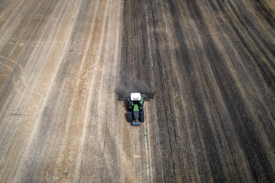 A tractor works the field on a private farm in Zhurivka, Kyiv region, Ukraine, Thursday, Aug. 10, 2023. Russia pulled out of a wartime agreement last month allowing Ukraine to ship grain to the world. With that and intensifying fighting in the Black Sea, Ukraine’s farmers are left wondering how they will stay in business and provide the food that's critical to people in developing nations struggling with hunger.(AP Photo/Efrem Lukatsky)