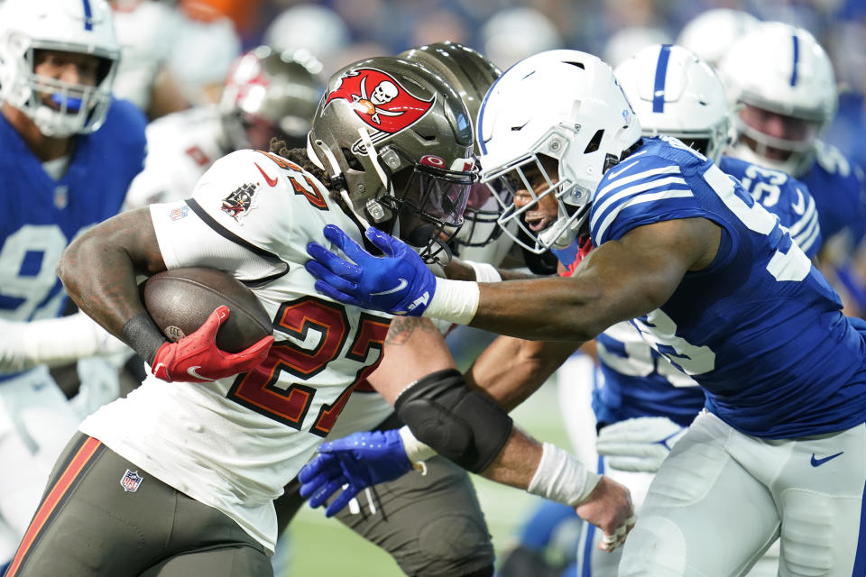 Tampa Bay Buccaneers' Ronald Jones (27) runs against Indianapolis Colts' Bobby Okereke (58) during the first half of an NFL football game, Sunday, Nov. 28, 2021, in Indianapolis. (AP Photo/Michael Conroy)