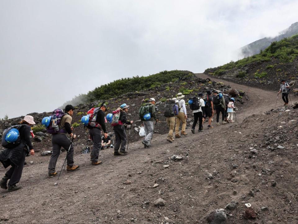 Visitor climb the slopes of Mount Fuji, Japan’s highest peak, on 31 August 2023 (Getty)