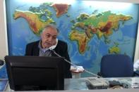 Palestinian travel agent Nabil Shurafa speaks on a phone at his office in Gaza City February 4, 2016. REUTERS/Ibraheem Abu Mustafa